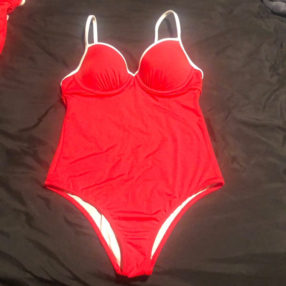One piece, backless baithing suit. Cutout back.